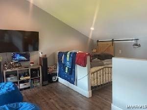 bedroom with dark wood-style floors and lofted ceiling