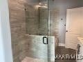 full bathroom with a shower stall