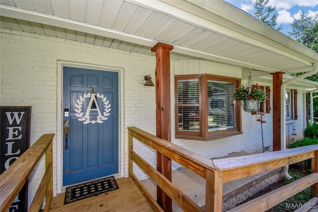 view of exterior entry with covered porch