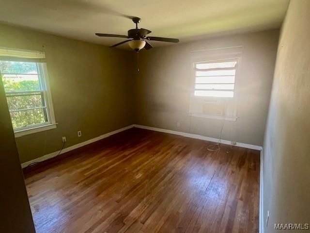 spare room with ceiling fan and hardwood / wood-style flooring