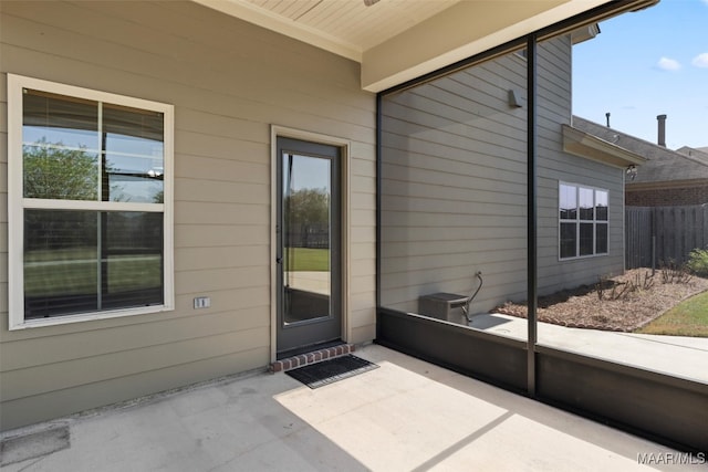 doorway to property with central AC unit and a patio