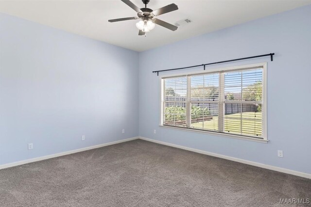 spare room featuring carpet floors and ceiling fan