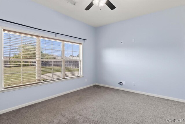 carpeted empty room featuring ceiling fan