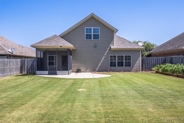 rear view of house with a lawn, a sunroom, and a patio