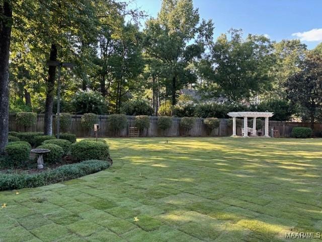 view of yard with fence and a pergola