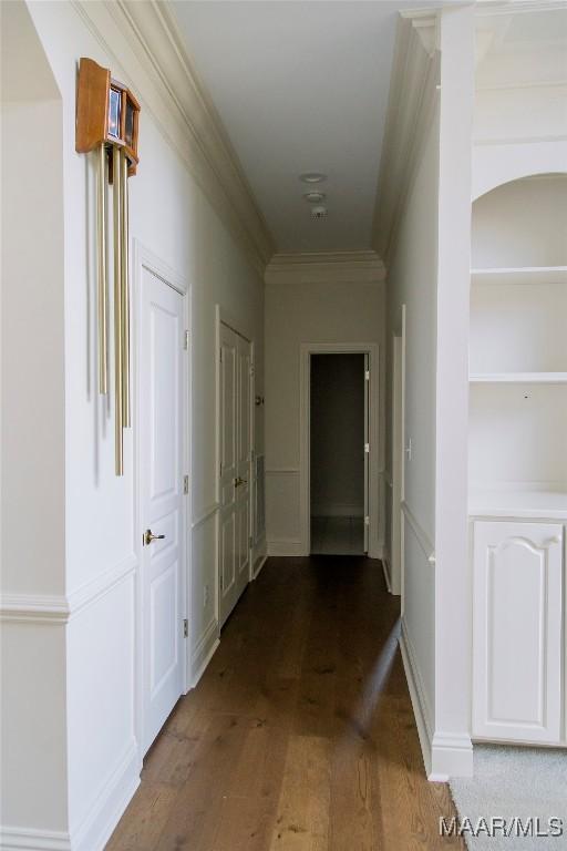 hallway featuring dark wood-style floors and ornamental molding