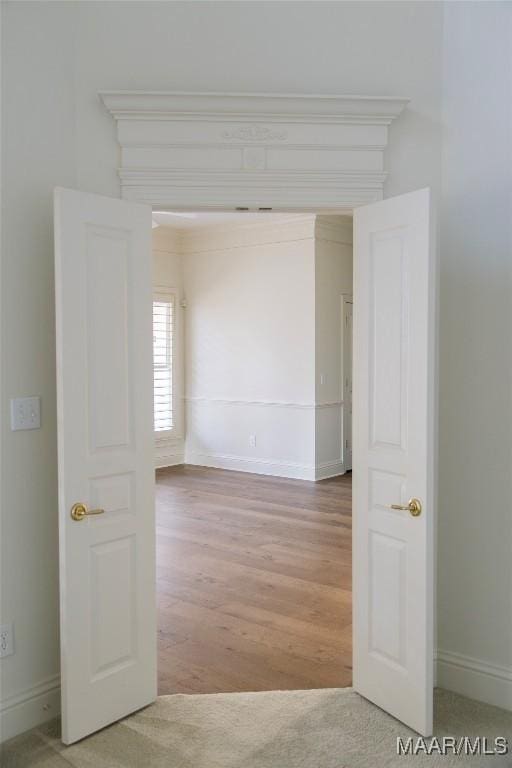 empty room with baseboards and wood finished floors