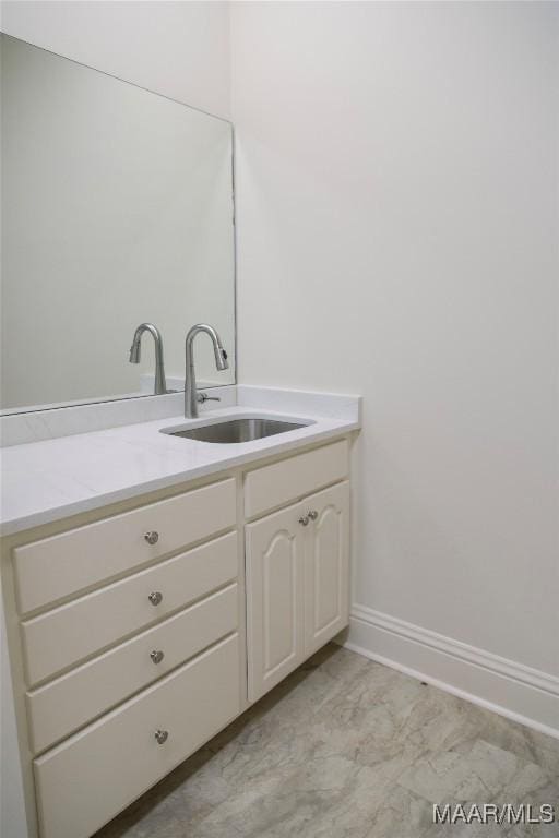 bathroom featuring baseboards and vanity