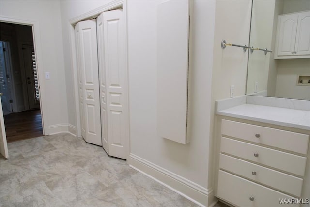 bathroom with vanity and baseboards