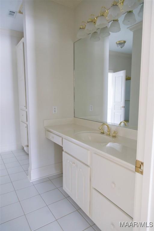 bathroom with tile patterned flooring, visible vents, baseboards, and vanity