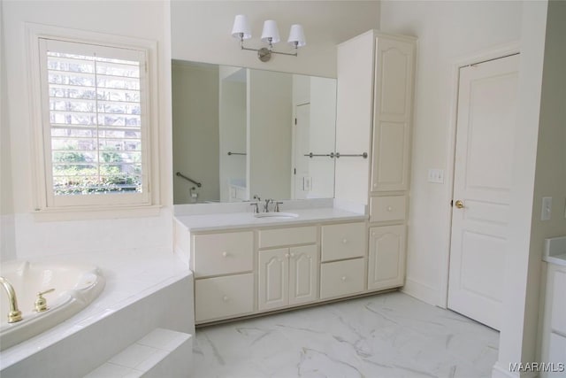 bathroom featuring a bath, marble finish floor, and vanity