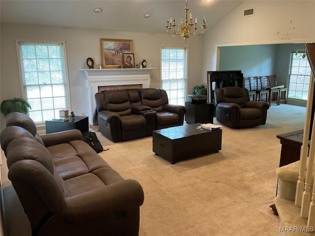 carpeted living room featuring lofted ceiling and a chandelier