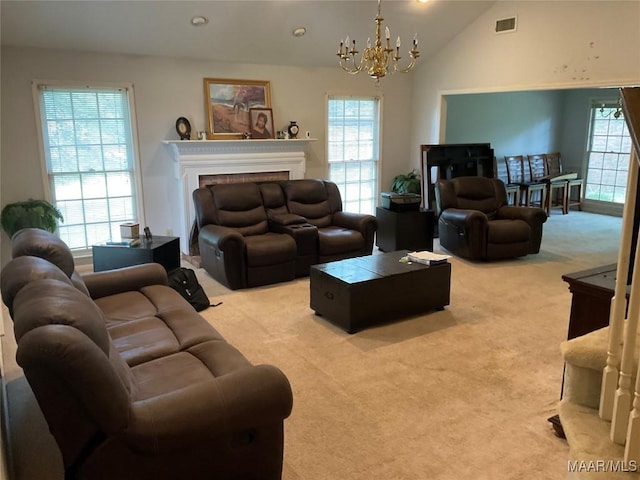 living room featuring a fireplace, a notable chandelier, visible vents, light carpet, and lofted ceiling