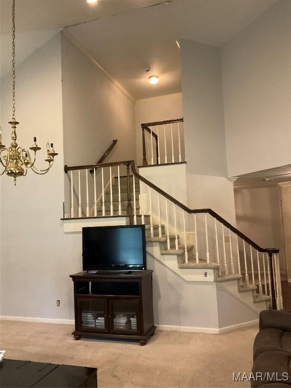unfurnished living room with baseboards, stairway, and carpet floors