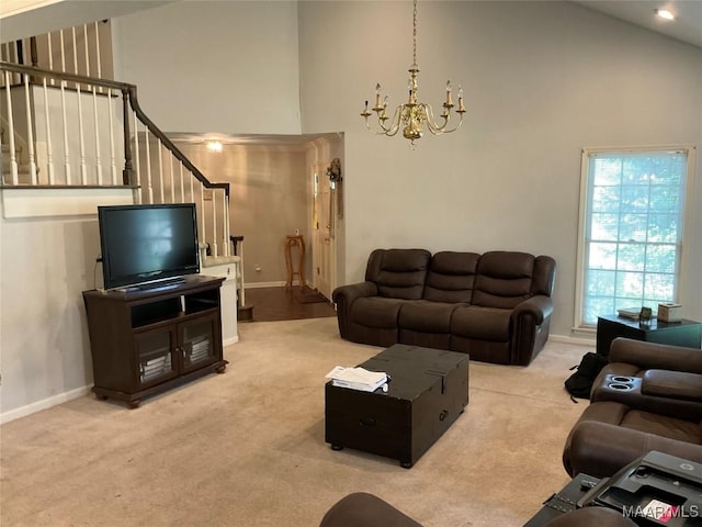 carpeted living area featuring an inviting chandelier, high vaulted ceiling, and baseboards