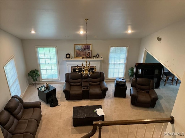 living room featuring visible vents, a healthy amount of sunlight, and carpet flooring