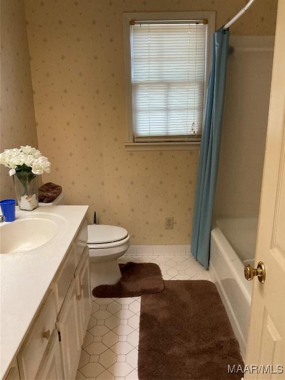 bathroom with vanity, shower / bath combination with curtain, toilet, tile patterned flooring, and wallpapered walls