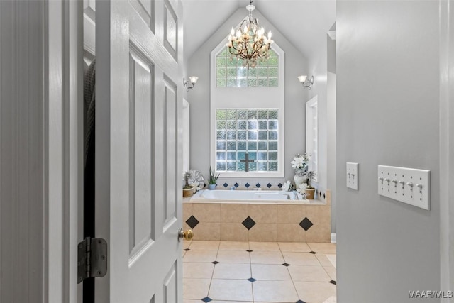 bathroom with tile patterned floors, a relaxing tiled tub, a chandelier, and a healthy amount of sunlight