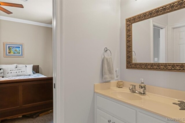 bathroom featuring ceiling fan, crown molding, and vanity