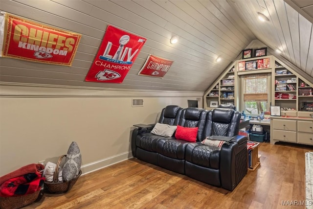 cinema room with vaulted ceiling, wood-type flooring, and wood ceiling