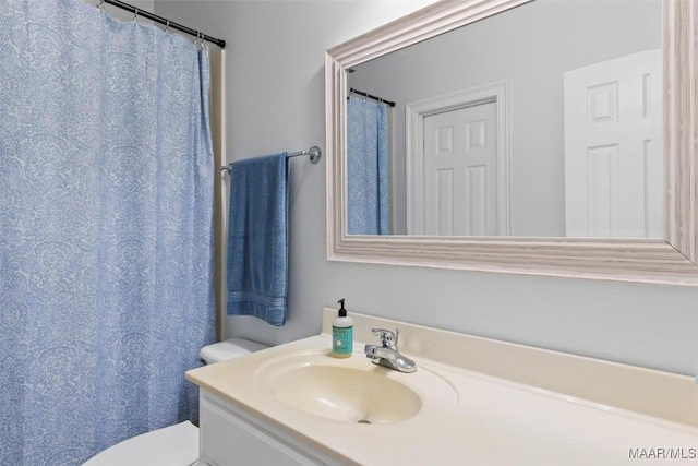 bathroom with toilet and vanity