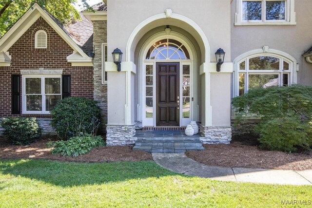 property entrance with a yard