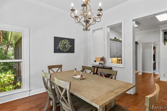 dining area featuring dark hardwood / wood-style floors, crown molding, and an inviting chandelier