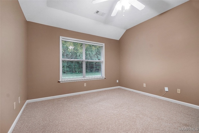 empty room with ceiling fan, carpet flooring, and lofted ceiling