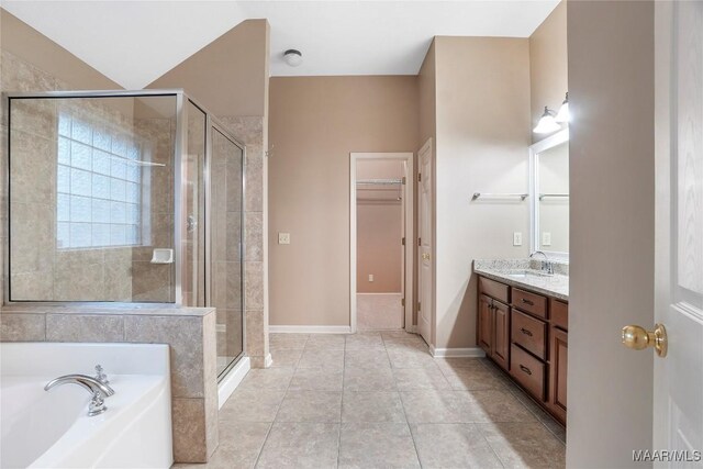 bathroom with tile patterned floors, independent shower and bath, and vanity