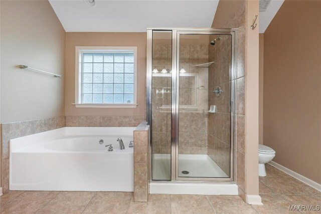 bathroom with tile patterned floors, separate shower and tub, and toilet