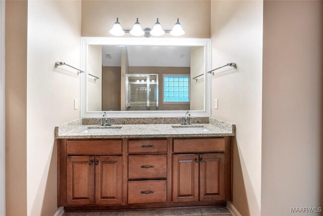 bathroom featuring tile patterned flooring, walk in shower, and vanity