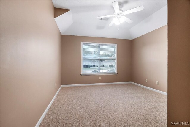 carpeted empty room with ceiling fan and lofted ceiling