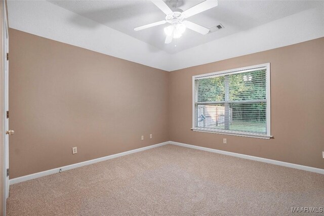 spare room featuring ceiling fan and carpet flooring