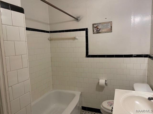 1949 Johnson St, Montgomery, AL 36110 - bathroom featuring tile walls, a sink, and toilet