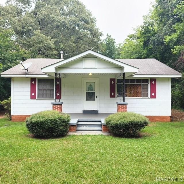 1949 Johnson St, Montgomery, AL 36110 - view of front of home with a porch, a front lawn, and a shingled roof