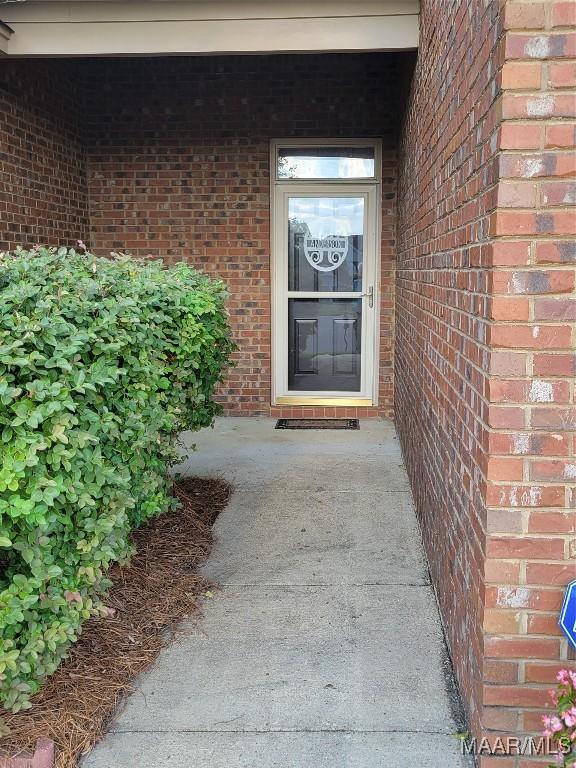 property entrance with brick siding