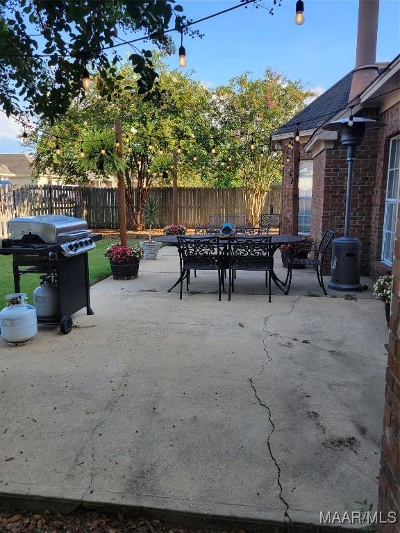 1315 Richton Rd, Montgomery, AL 36117 - fenced backyard featuring outdoor dining area, area for grilling, a patio area, and central air condition unit