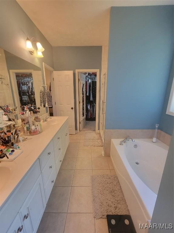 bathroom with vanity, tile patterned floors, and a bathing tub