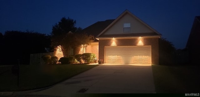 traditional home featuring concrete driveway and a garage