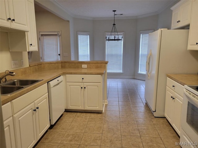 kitchen featuring white appliances, white cabinets, sink, decorative light fixtures, and kitchen peninsula