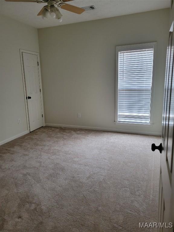1315 Richton Rd, Montgomery, AL 36117 - empty room featuring carpet floors, a ceiling fan, and baseboards