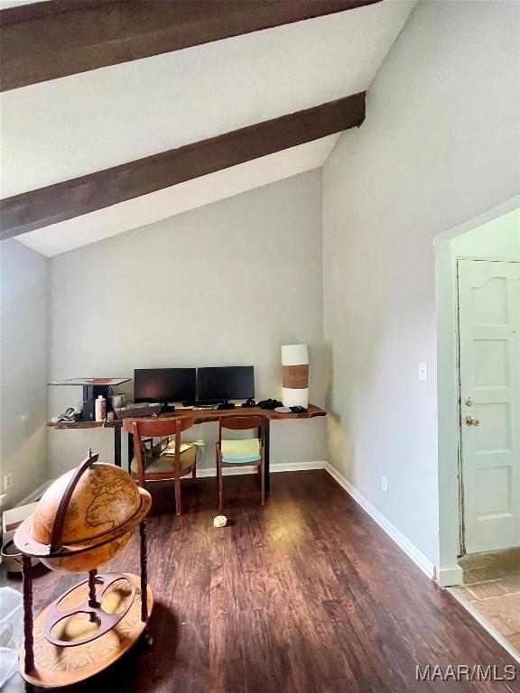 office space featuring vaulted ceiling with beams, baseboards, and wood finished floors