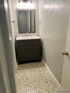 bathroom with vanity and baseboards