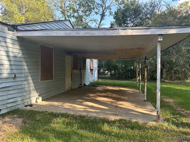 exterior space with a lawn and a carport