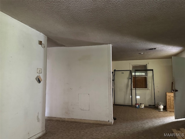 spare room featuring a textured ceiling