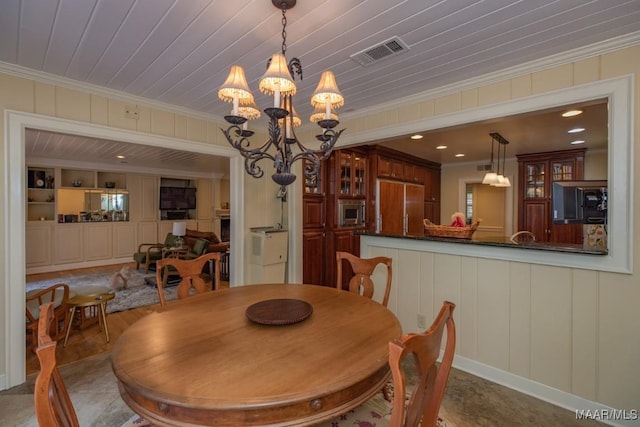 dining area featuring recessed lighting, an inviting chandelier, visible vents, and crown molding