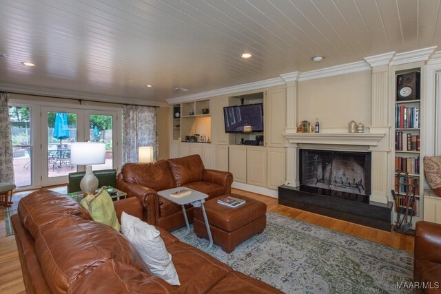 living room with built in features, wood ceiling, ornamental molding, light hardwood / wood-style floors, and a fireplace