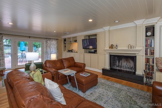 living room with ornamental molding, light wood-type flooring, wood ceiling, and built in features