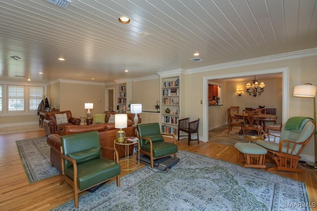 sitting room featuring crown molding, visible vents, and wood finished floors