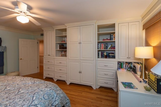 bedroom featuring ceiling fan, light wood-type flooring, and crown molding